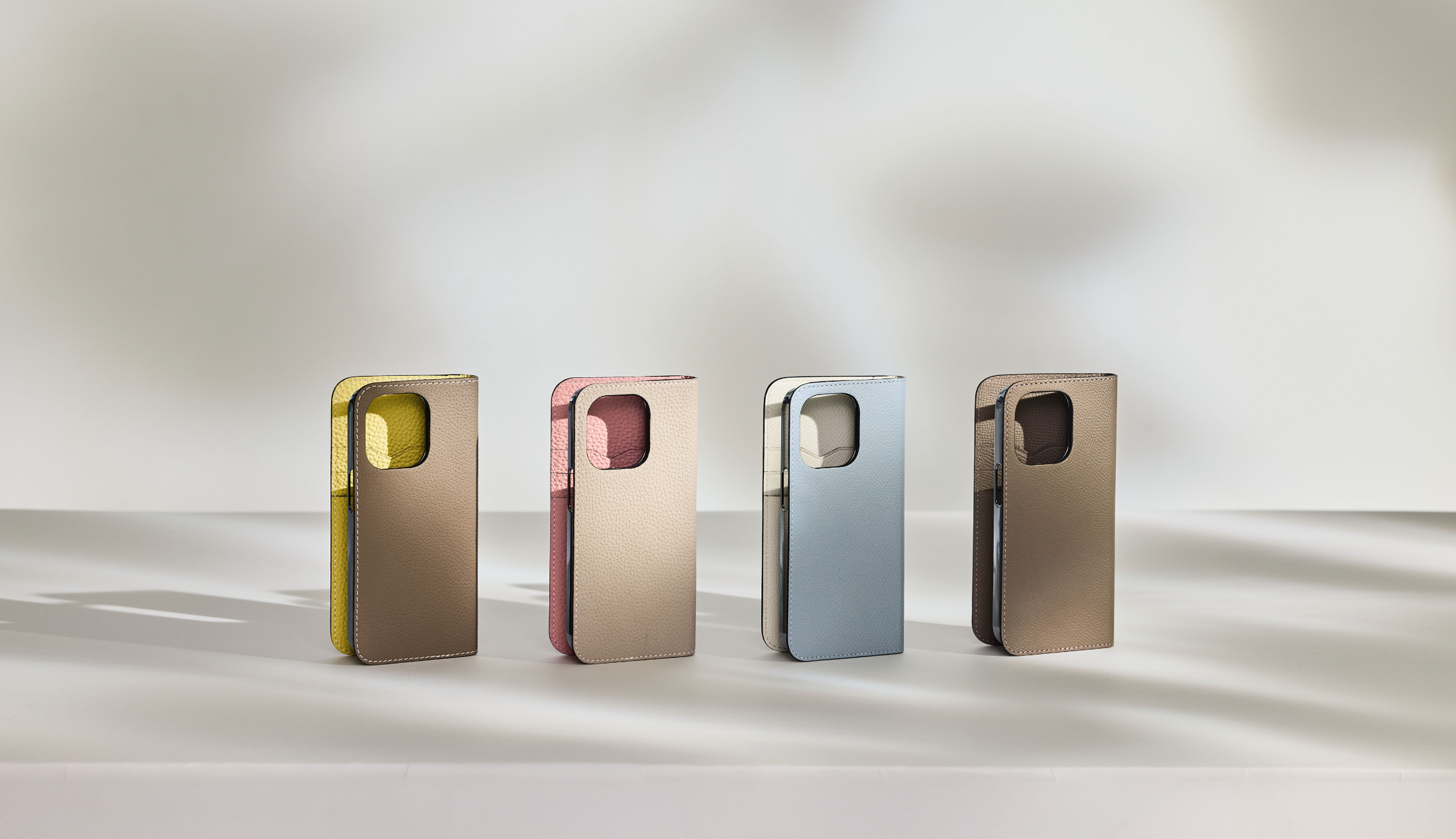 Various iPhone leather cases in several colors next to each other, made of high-quality full-grain leather.